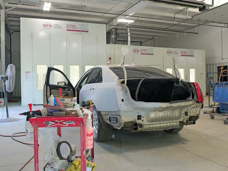 Rear quarter panel in primer during body repair at Jim Winter Auto Body in Jackson, Michigan